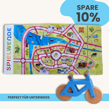Handtuch Mobilitätsset To Go mit Spielteppich und Holzfahrrad, ideal für unterwegs, spart 10%.